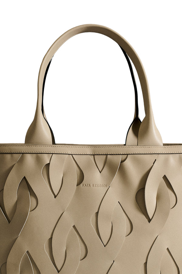 Close-up view of Kata Szegedi woven leather tote bag in beige, shown against a plain white background.