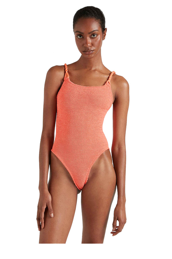 A close-up of a woman wearing Hunza G Camille swimsuitin Coral, shown against a plain white background.
