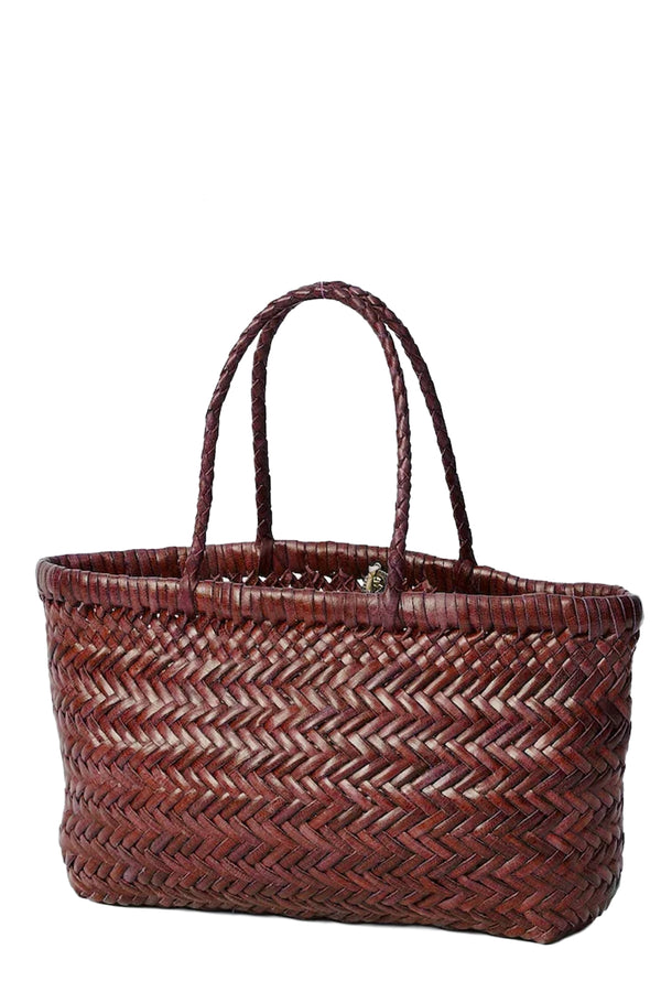 Rotated view of Dragon Diffusion woven leather tote bag in dark red, shown against a plain white background.