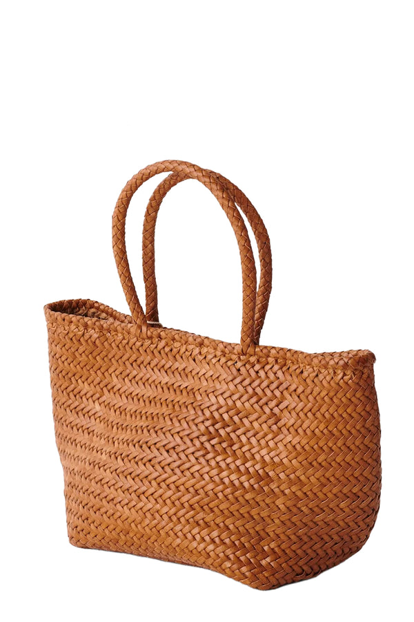 Rotated view of Dragon Diffusion oval woven leather tote bag in light brown, shown against a plain white background.
