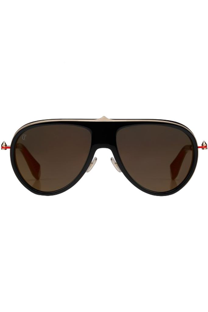 Christian Louboutin moto sunglasses in brown with black frame and golden spine in the middle, shown against a plaid white background.