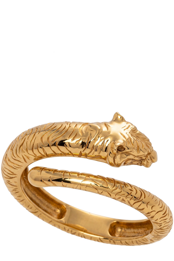 Raquel Diniz metal bracelet in gold with scratched patterns on the surface, shown against a plaid white background.