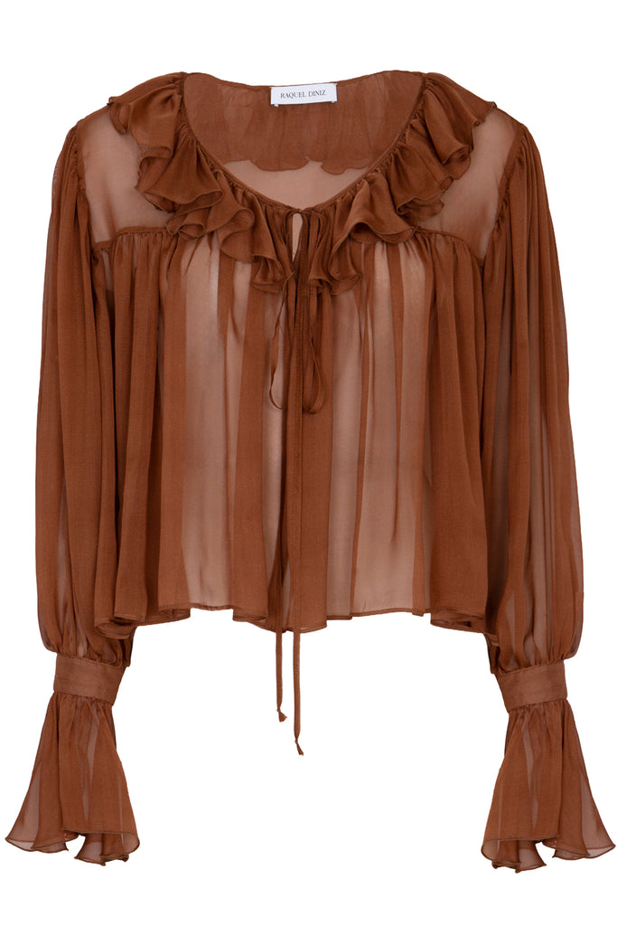 Raquel Diniz translucent blouse in brown with frills, shown against a plaid white background.