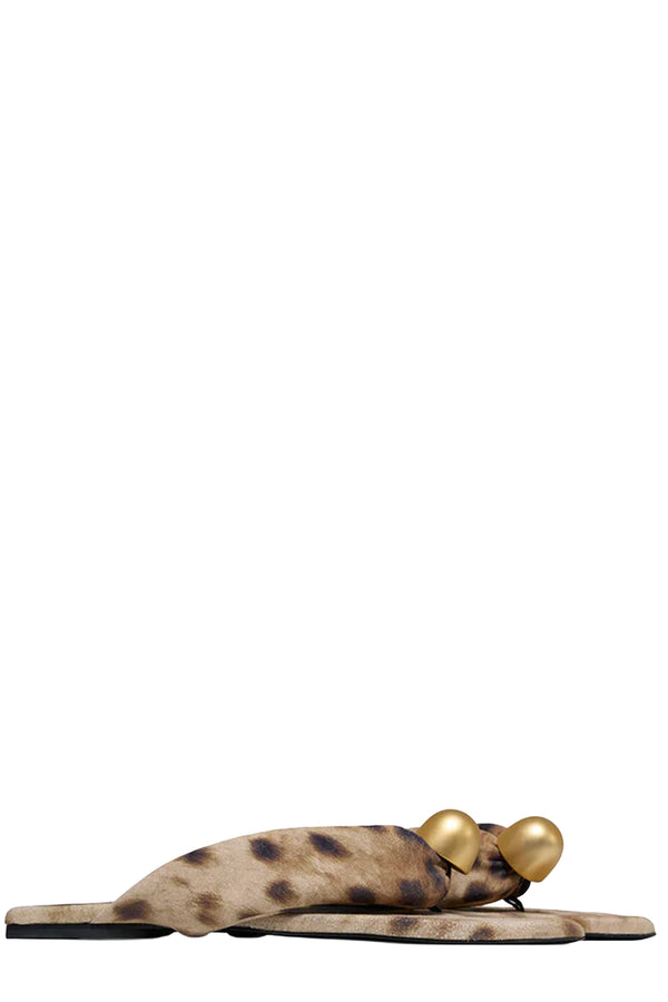 Rotated view of a pair of Vanda Novak flat sandals in brown and beige made from leather with golden detail, shown against plaid white background. 
