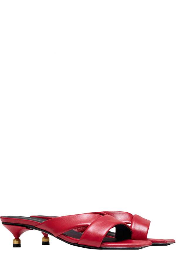 Rotated view of a pair of Vanda Novak heeled sandals in red made from leather with golden details, shown against plaid white background.