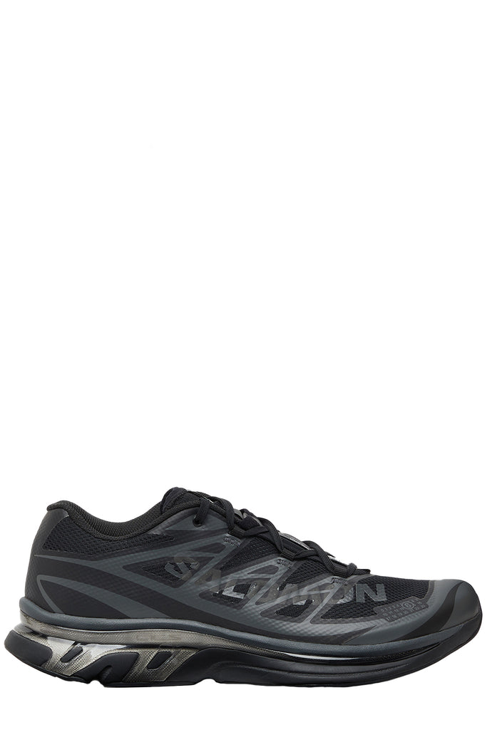 MM6 Maison Margiela sneakers in black with grey touch, shown against a plain white background.