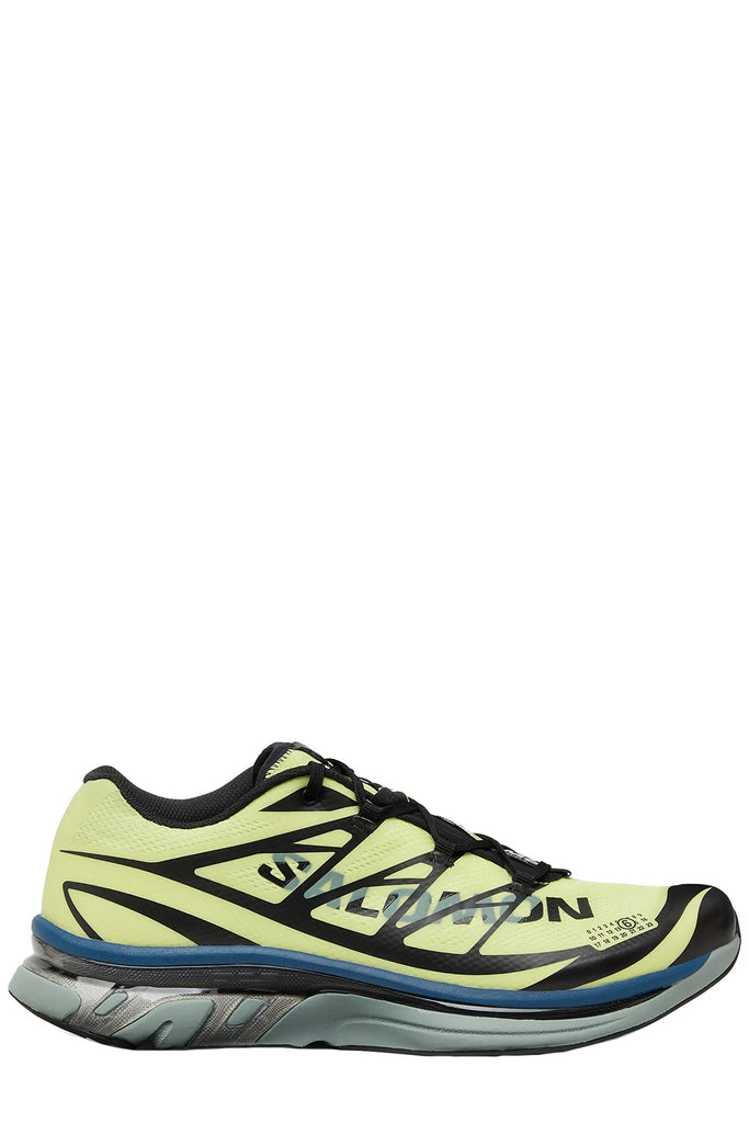 MM6 Maison Margiela sneakers in pale yellow, black, grey with a touch of dark blue, shown against a plain white background.