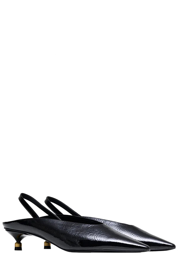 Rotated view of a pair of Vanda Novak heeled sandals in black made from leather with golden detail, shown against plaid white background.