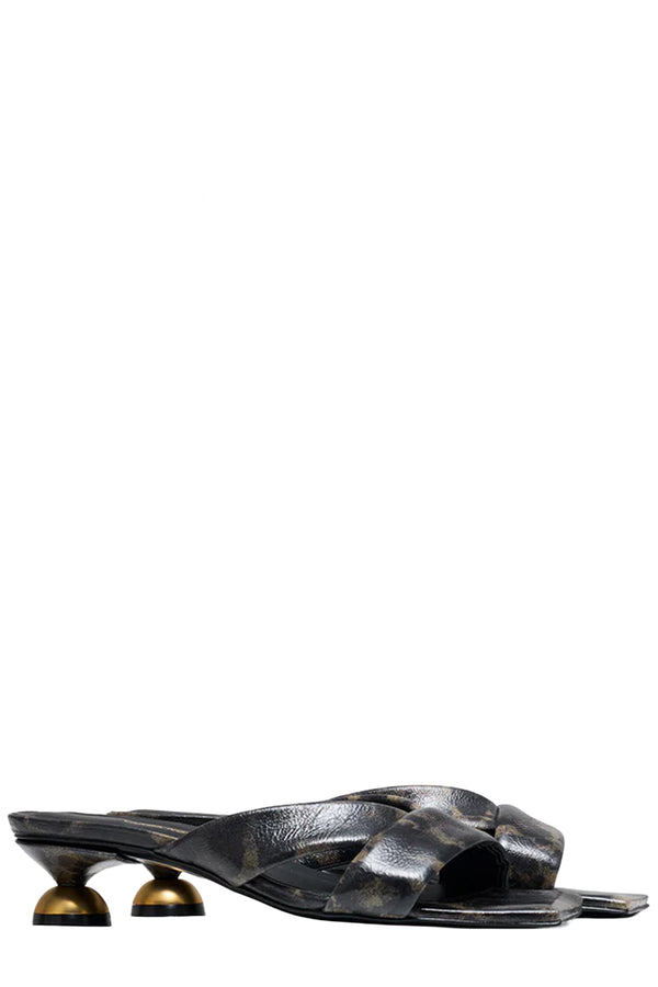 Rotated view of a pair of Vanda Novak heeled sandals in Dark brown and black made from leather with golden detail, shown against plaid white background. 
