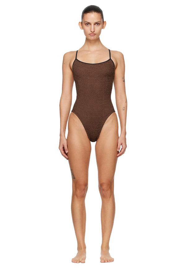A front view of a model wearing Hunza G spaghetti strap swimsuit in Brown with black edges, shown against a plain white background.