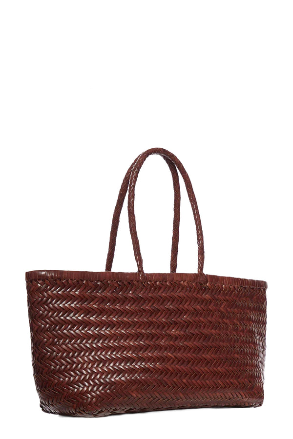 Rotated view of Dragon Diffusion rectangular woven leather tote bag in brown, shown against a plain white background.