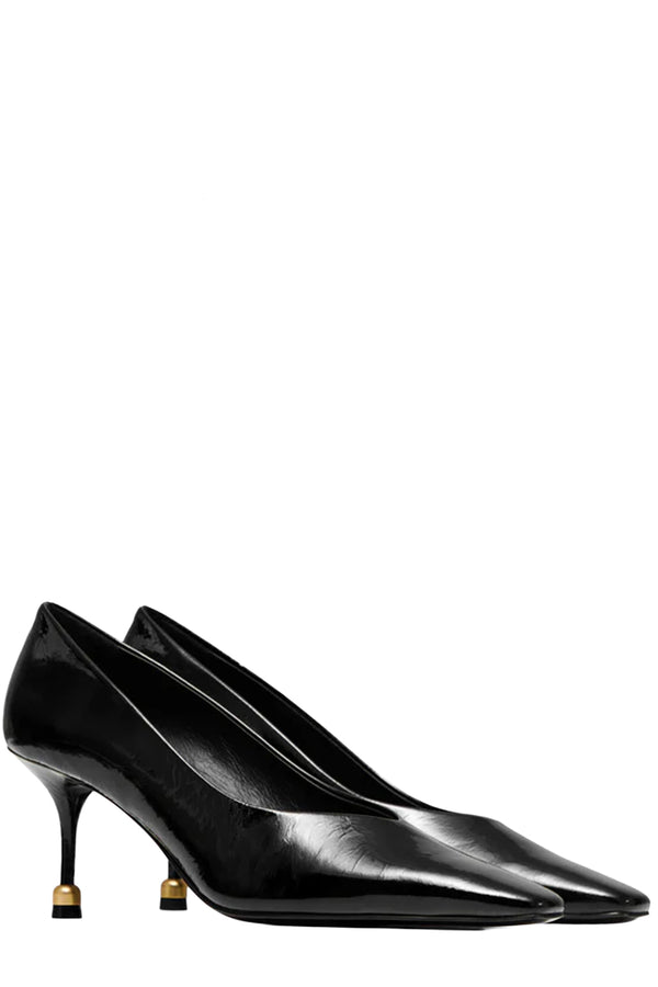 Rotated view of a pair of Vanda Novak high heels in black made from leather with golden detail, shown against plaid white background. 